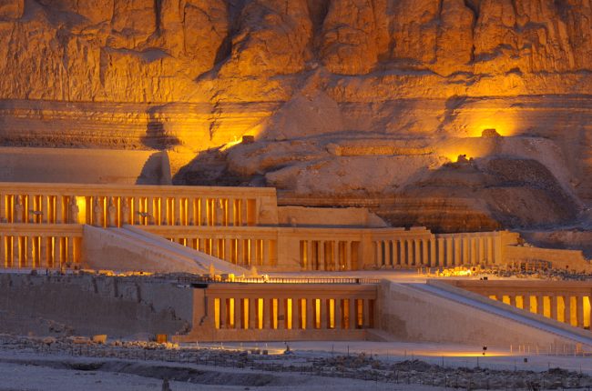 Hatshepsut's mortuary temple rises against a desert bluff.